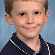 Braxton joined the competition — help win amazing prizes! child, boy, smile, portrait, school_photo, short_hair, blue_background, collared_shirt, casual_clothing, young, face, head, person, happy, looking_at_camera, indoor, studio, childhood, cute, innocent