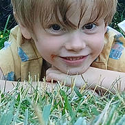 Declan is registered to the contest to win money with this photo: child, blonde_hair, grass, smile, outdoor, face, portrait, happy, casual_clothing, closeup, nature, young, messy_hair, cheeky, playful, person, summer, greenery, daylight, fun