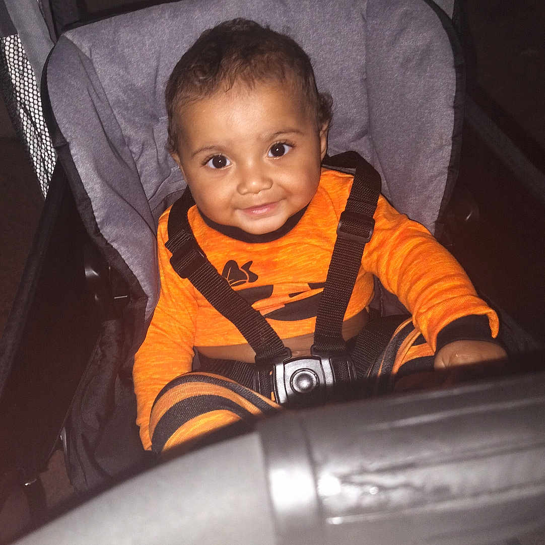Kay'Shon is registered to the contest to win money with this photo: accessories, alloywheel, baby, bed, car, car_interior, carseat, carwheel, face, furniture, head, machine, person, photography, portrait, spoke, strap, stroller, transportation, vehicle