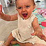 Romy participe au concours pour gagner de l'argent avec cette photo : baby, child, knitted_dress, happy, smiling, indoor, play_mat, barefoot, reaching_out, cute, infant, home, floor, toy_brush, person, toddler, sitting, bright, expression, young
