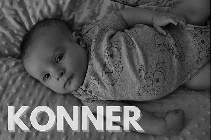 Konner is registered to the contest to win money with this photo: baby, black_and_white, cheek, chin, comfort, eyebrow, finger, flash_photography, gesture, grey, hairstyle, hand, happy, human_body, iris, lip, mouth, nose, person, skin