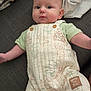 Jayce is registered to the contest to win money with this photo: baby, infant, face, clothing, onesie, winnie_the_pooh, couch, blanket, fabric, cute, child, portrait, soft, indoors, person, sleeves, button, skin, head, eyes