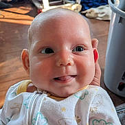 Jayce joined the competition — help win amazing prizes! baby, infant, smile, tongue, face, onesie, clothing, indoor, close_up, cute, child, person, expression, skin, head, happy, young, newborn, warm_light, background_blur