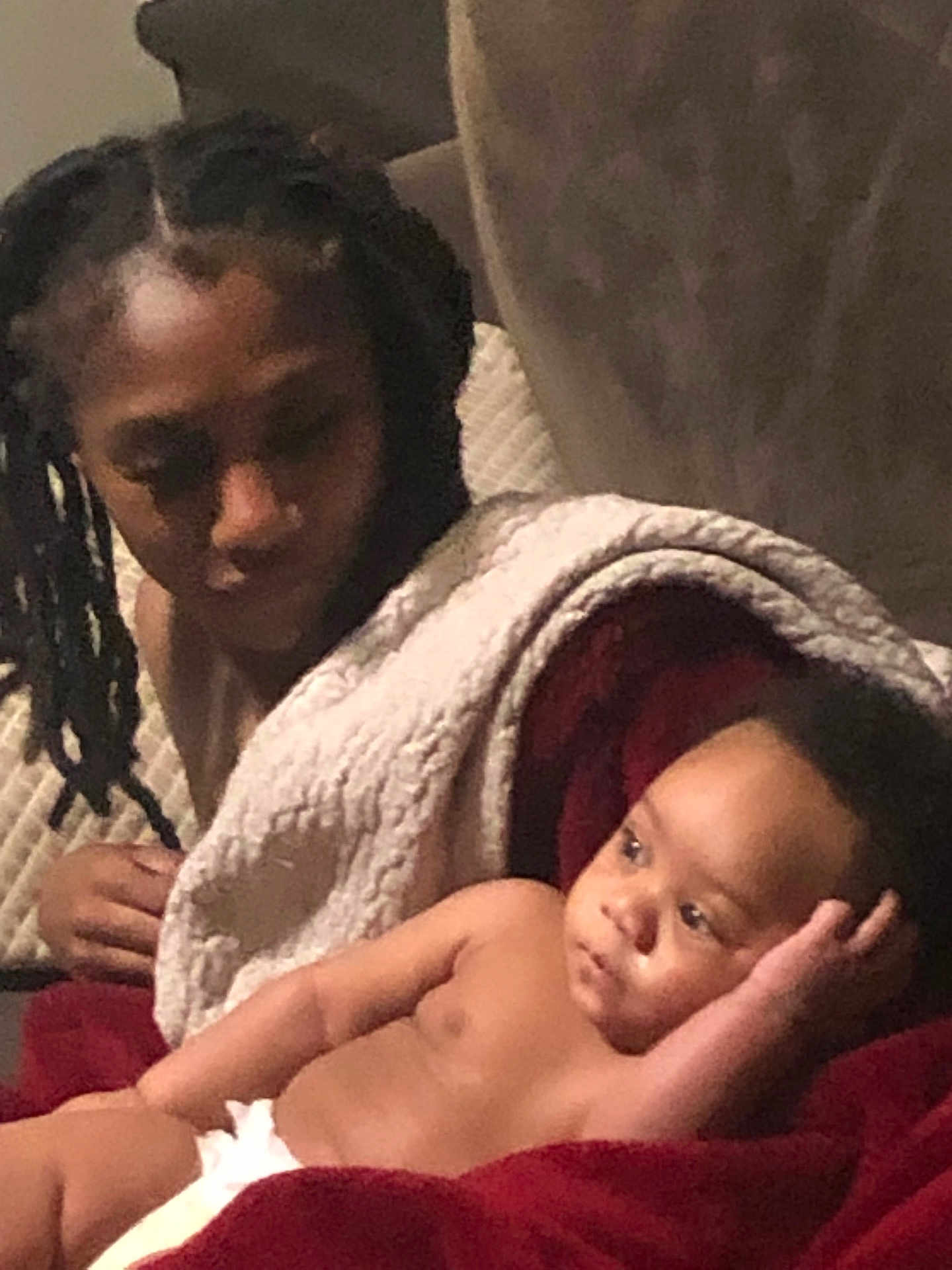 Kylin is registered to the contest to win money with this photo: child, baby, indoor, blanket, red_blanket, diaper, braided_hair, couch, relaxing, portrait, two_children, family, soft_lighting, comfort, warmth, expression, looking_away, wrapped_in_blanket, skin, sitting