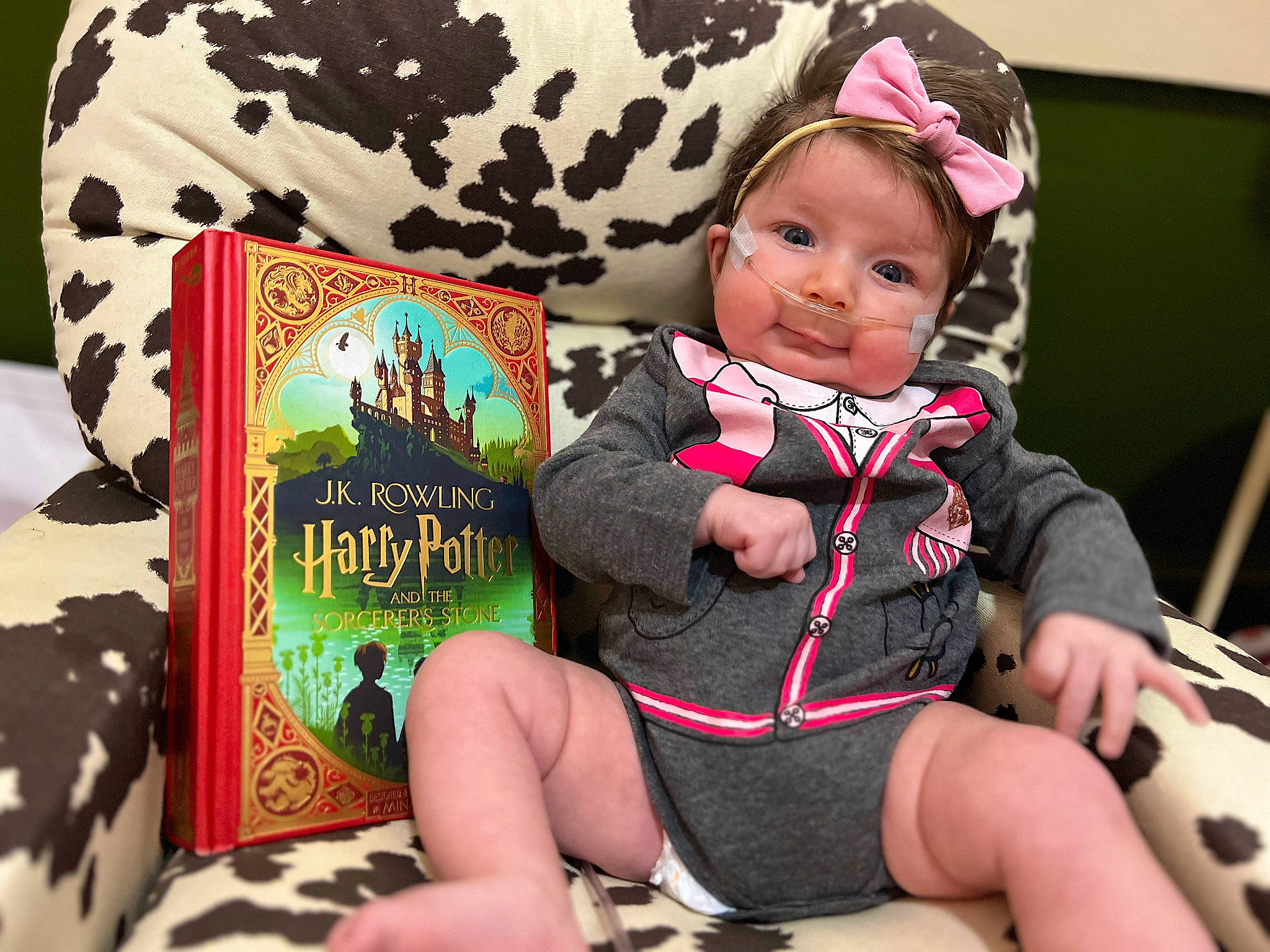 Joy joined the competition — help win amazing prizes! baby, baby_products, baby_toddler_clothing, book, child, comfort, fashion_accessory, happy, headwear, human_leg, knee, lap, pattern, person, pink, publication, sitting, sleeve, smile, sock