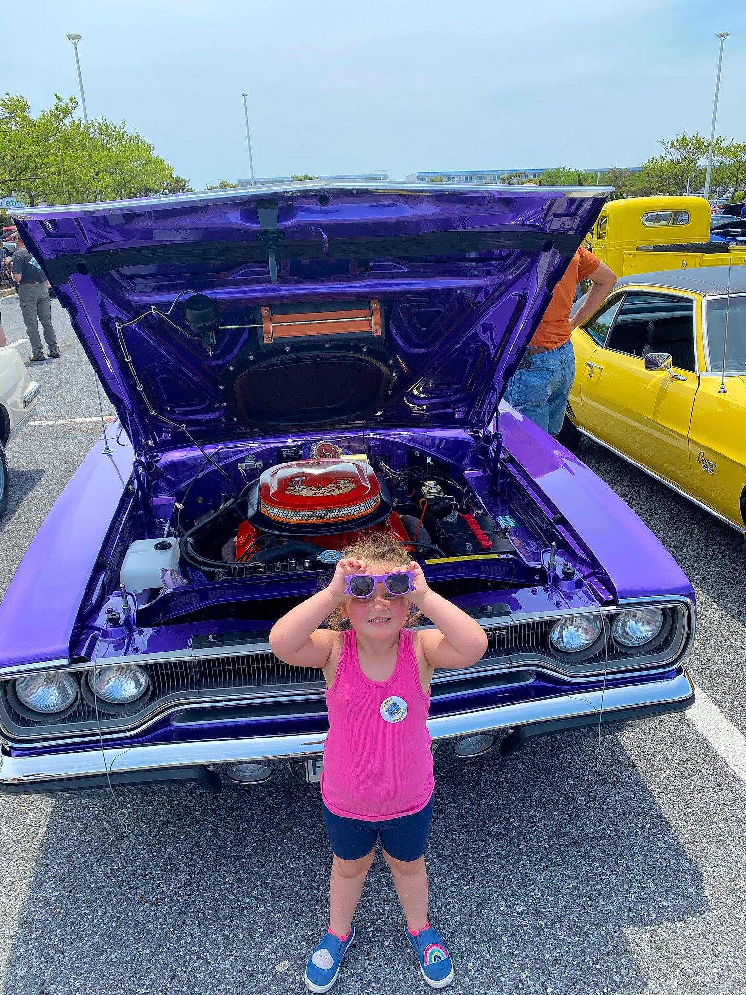 Blaire is registered to the contest to win money with this photo: auto_part, automotive_design, automotive_exterior, automotive_lighting, bumper, car, classic, classic_car, hardtop, hood, joy, kit_car, motor_vehicle, person, personal_luxury_car, pink, shorts, sky, tire, vehicle