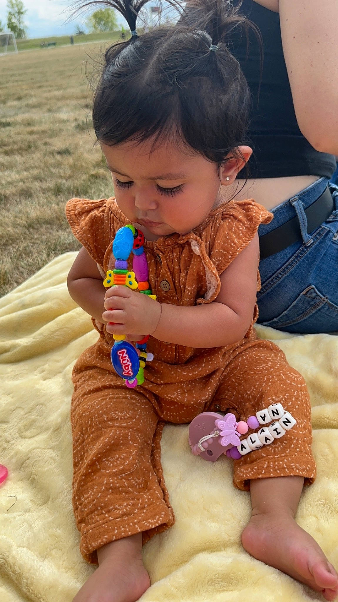 Alainna is registered to the contest to win money with this photo: baby_toddler_clothing, child, finger, fun, hair, hand, happy, head, human_leg, joint, mammal, nail, neck, pattern, person, pink, play, sitting, skin, thigh