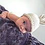 baby, infant, knitted_hat, bunny_ears, blanket, soft_texture, cute, face, eyes, skin, headwear, child, lying_down, indoors, portrait, closeup, expression, adorable, young, person