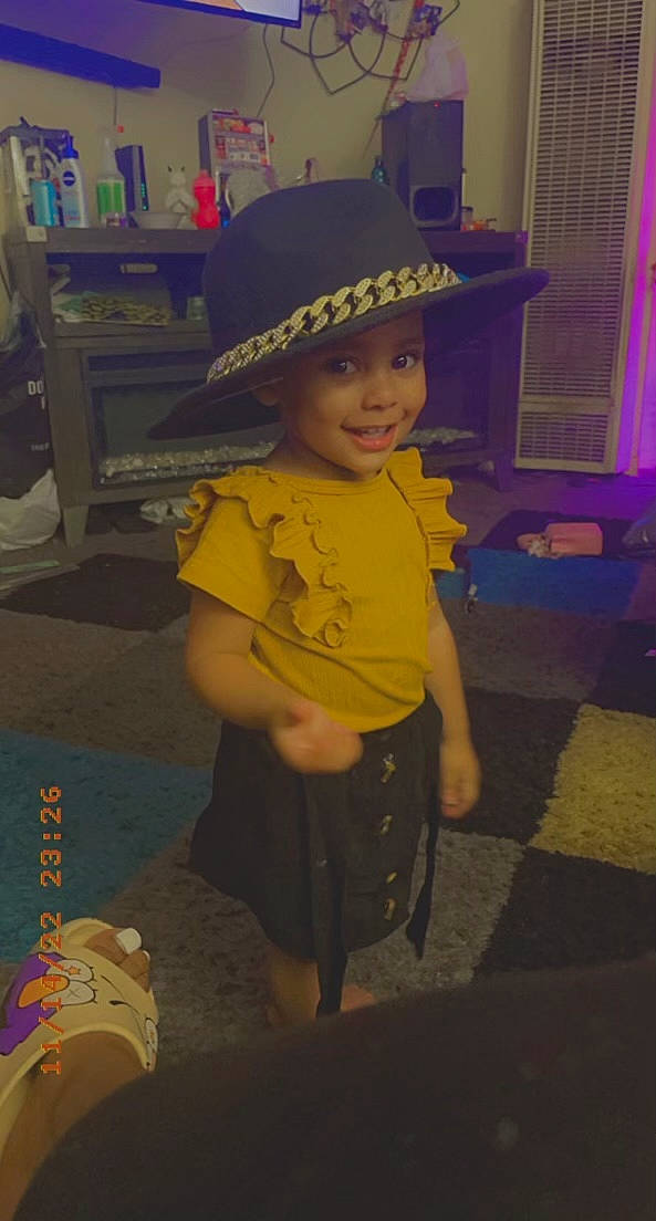 Kaliyah is registered to the contest to win money with this photo: baby, baby_toddler_clothing, cap, child, cool, electric_blue, event, fashion_accessory, flooring, fun, happy, hat, headwear, joy, person, play, room, shorts, sitting, smile