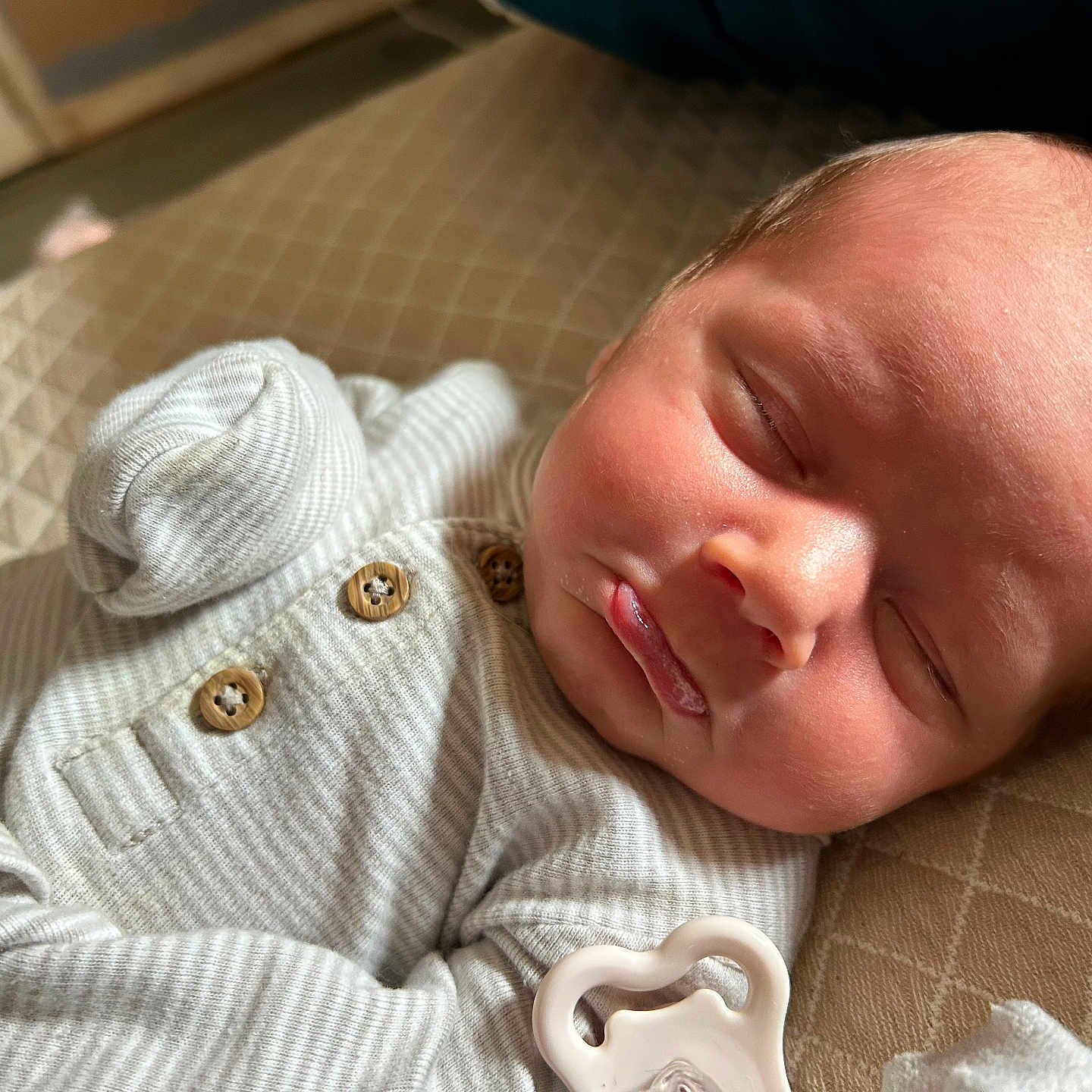 Koehn joined the competition — help win amazing prizes! baby, buttoned_clothing, child, closed_eyes, cozy, cute, face, head, indoor, infant, newborn, onesie, pacifier, peaceful, portrait, quilted_blanket, resting, skin, sleeping, soft_lighting