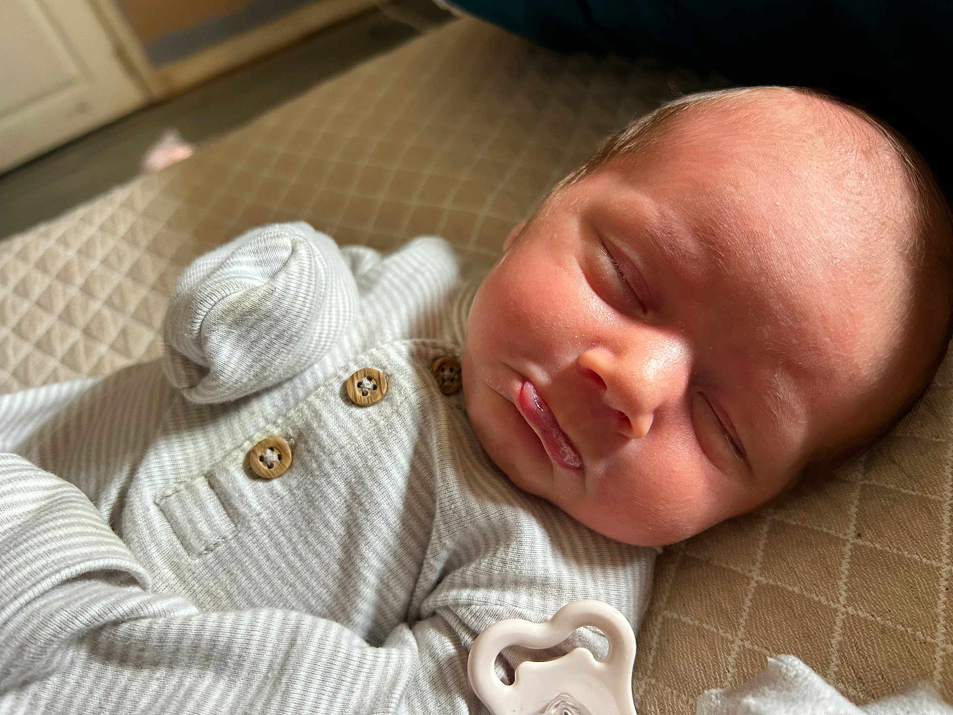 Koehn joined the competition — help win amazing prizes! baby, sleeping, infant, onesie, pacifier, face, closed_eyes, soft_lighting, indoor, quilted_blanket, newborn, cute, peaceful, skin, head, buttoned_clothing, portrait, resting, cozy, child