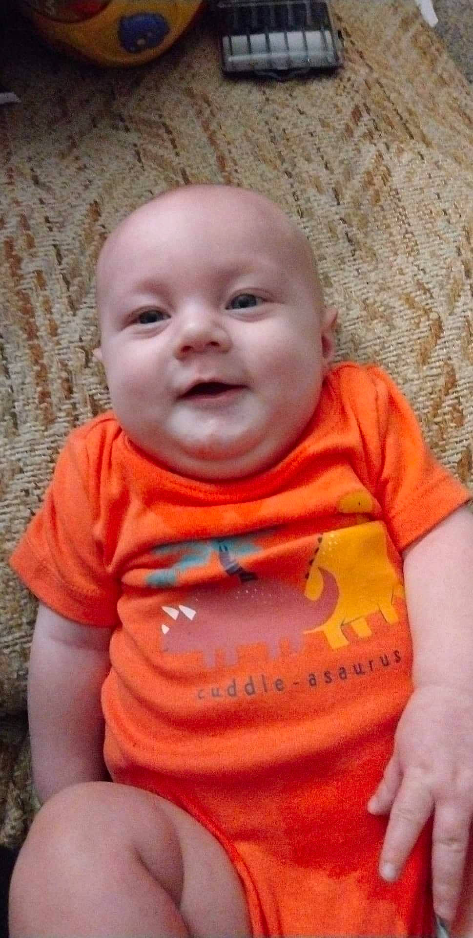 Timothy joined the competition — help win amazing prizes! baby, baby_toddler_clothing, cheek, chin, eye, fun, grass, hairstyle, happy, head, mouth, nose, orange, person, pink, skin, sleeve, smile, standing, t_shirt