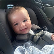 Aries is registered to the contest to win money with this photo: baby, car_seat, child, infant, smile, seatbelt, blanket, car_interior, straps, happy, cute, face, young_child, safety, clothing, head, person, transportation, comfort, portrait
