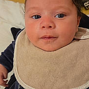 Kaïs participe au concours pour gagner de l'argent avec cette photo : baby, bib, blue_eyes, child, closeup, clothing, cute, expression, eyelashes, fabric, face, head, indoors, infant, panda_design, person, portrait, skin, soft, young