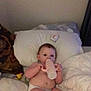 Daisy joined the competition — help win amazing prizes! baby, diaper, bottle, bed, pillow, blanket, indoor, child, infant, person, cute, relaxing, lying_down, soft, cozy, young, feeding, head, face, hand