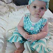 Daisy joined the competition — help win amazing prizes! baby, child, infant, bed, blanket, clothing, headband, sitting, indoors, person, cute, young, portrait, feet, hands, fabric, polka_dot, blue, white, soft