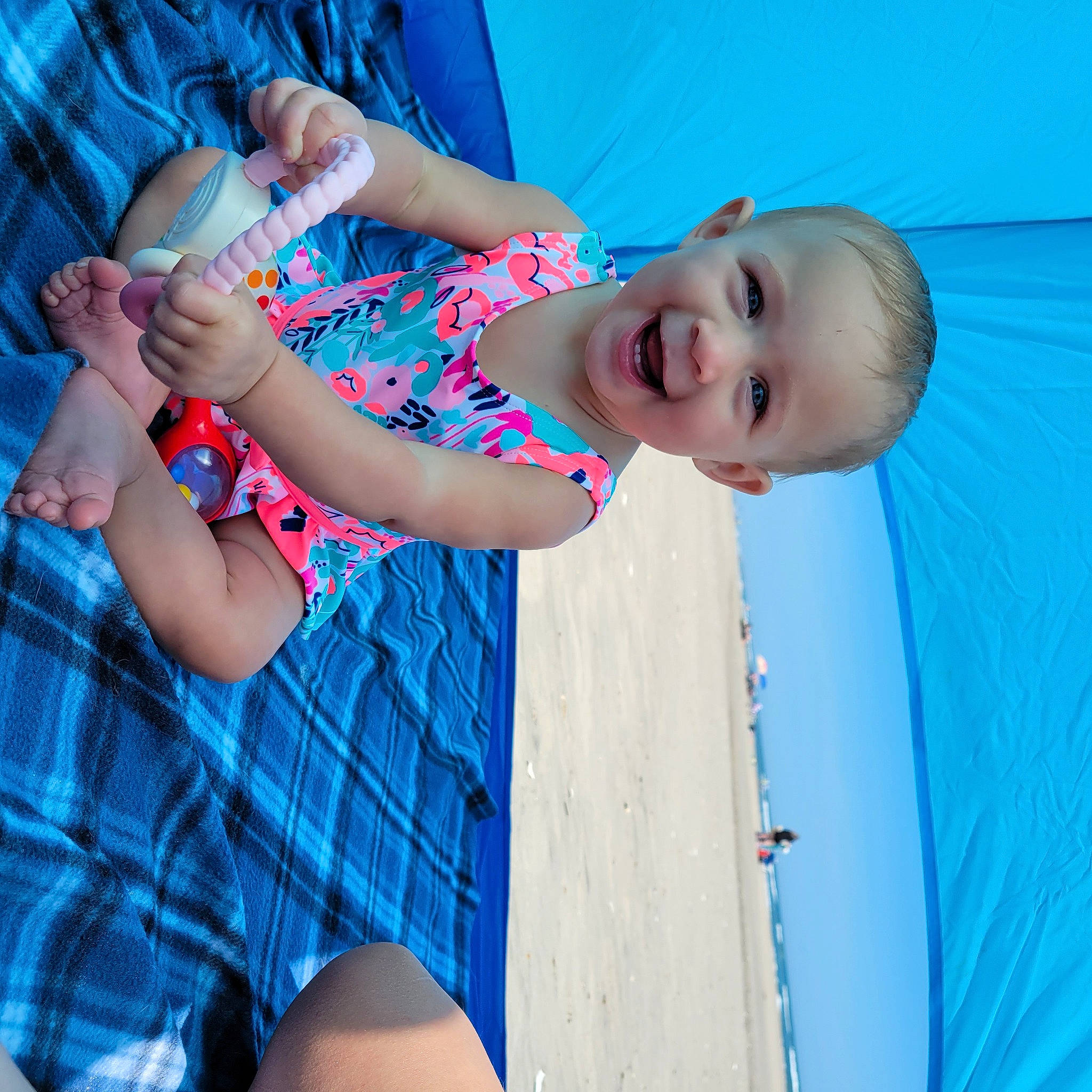 Brinley is registered to the contest to win money with this photo: arm, azure, blue, elbow, gesture, hand, happy, human_body, joint, joy, muscle, neck, person, shoulder, skin, sky, sleeve, smile, standing, tartan