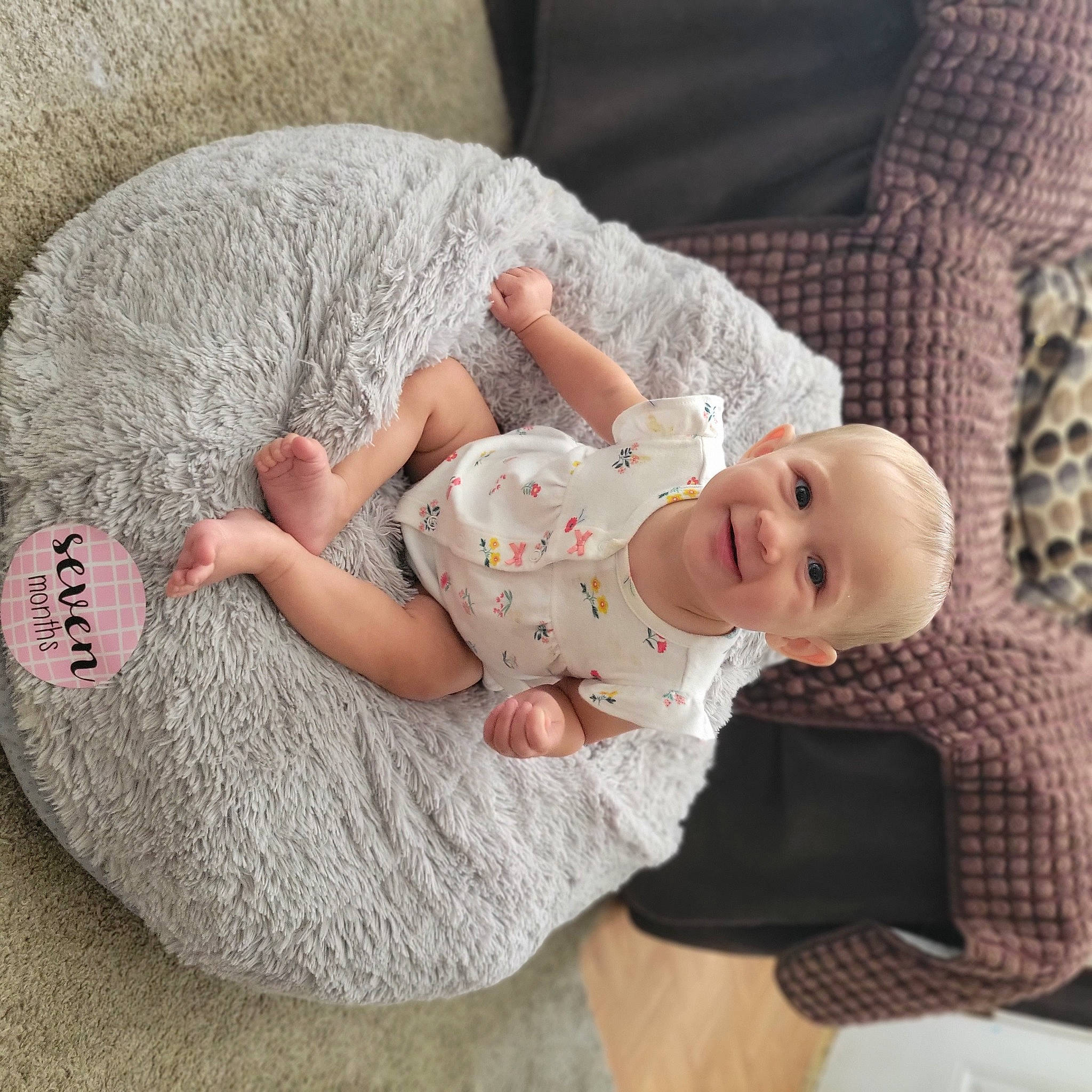 Brinley joined the competition — help win amazing prizes! baby, baby_sleeping, baby_toddler_clothing, child, comfort, couch, finger, foot, human_leg, joy, lap, linens, person, room, sitting, skin, sleeve, smile, sock, textile