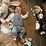 Victor participe au concours pour gagner de l'argent avec cette photo : baby, infant, smiling, plush_toy, stuffed_animal, bear_rug, overalls, striped_clothing, cute_patch, wooden_floor, playtime, child, lying_down, happy, indoors, soft_toy, giraffe_toy, decor, home, four_months
