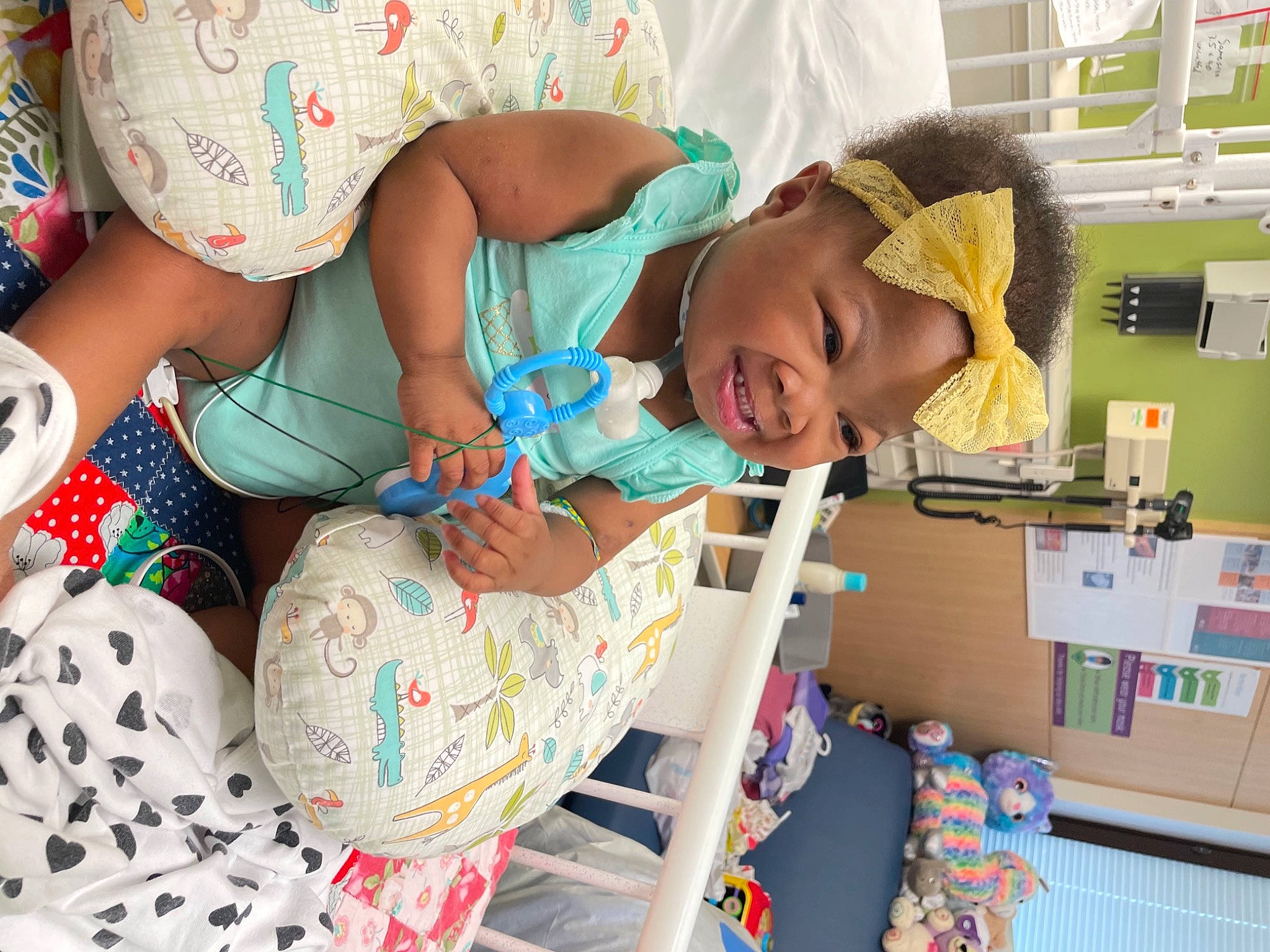 Taliyah is registered to the contest to win money with this photo: baby, baby_toddler_clothing, child, event, fun, happy, hat, headwear, human_leg, lap, linens, party, pattern, person, play, room, shelf, smile, sun_hat, textile