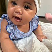 Nara Holloway joined the competition — help win amazing prizes! baby, infant, child, headband, blue_striped_clothing, white_blanket, close_up, face, eyes, hands, cute, indoors, skin, smiling, ruffles, portrait, lying_down, soft_texture, adorable, human