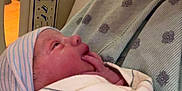 Camryn Faye is registered to the contest to win money with this photo: newborn, baby, hospital, blanket, swaddle, gown, person, infant, bed, face, hand, hospital_bed, medical, patient, striped, pink, blue, striped_hat, closeup, indoor