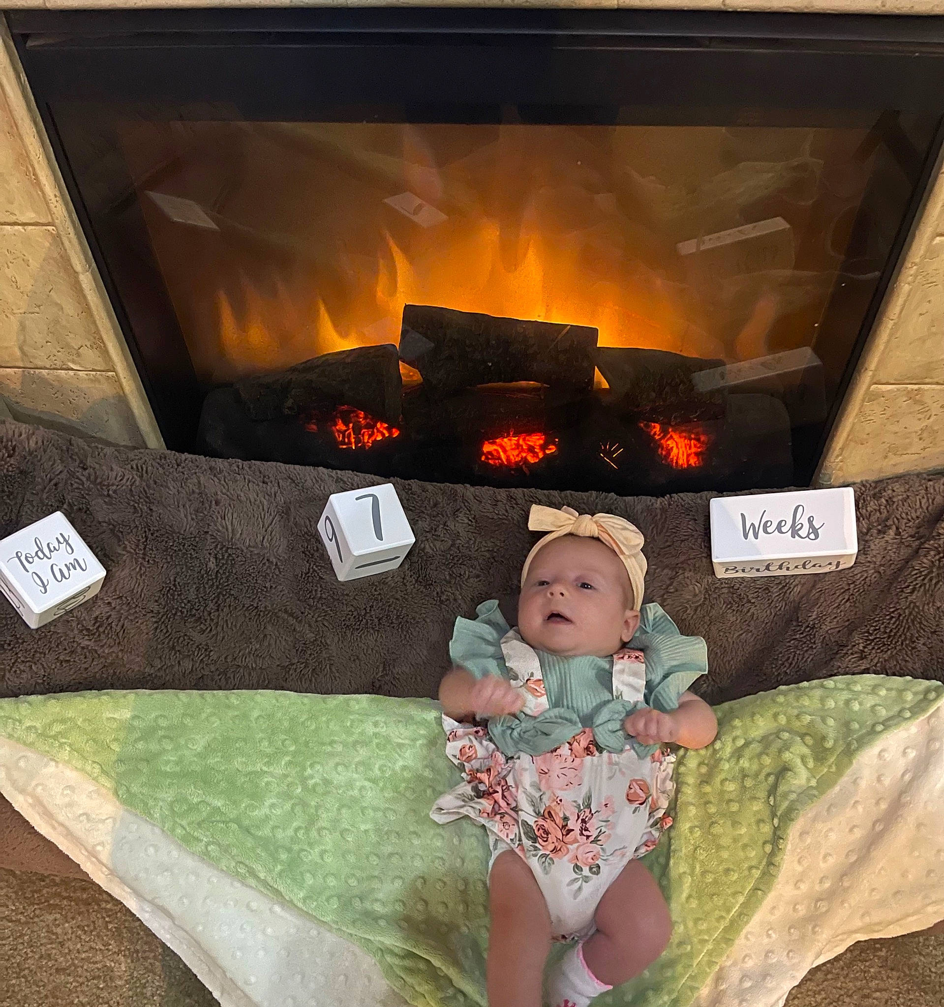 Annalise is registered to the contest to win money with this photo: baby, comfort, couch, fictional_character, fire, fireplace, flooring, fun, gas, grass, hearth, heat, illustration, leisure, linens, pc_game, person, room, thigh, toddler