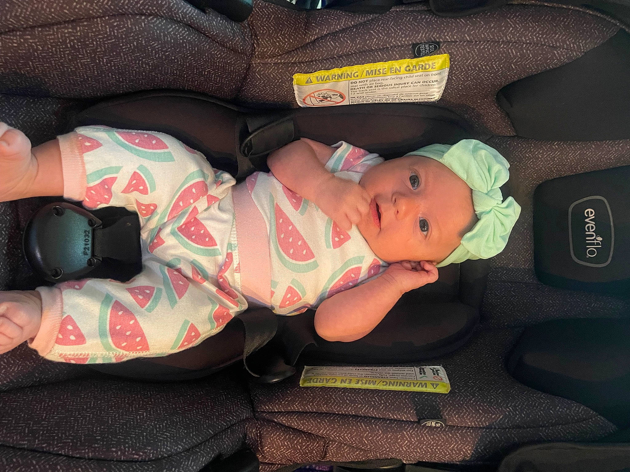 Annalise is registered to the contest to win money with this photo: baby, baby_carriage, baby_products, baby_toddler_clothing, car_seat, child, comfort, elbow, finger, hat, headwear, human_leg, lap, leg, nap, pattern, person, room, sitting, sock