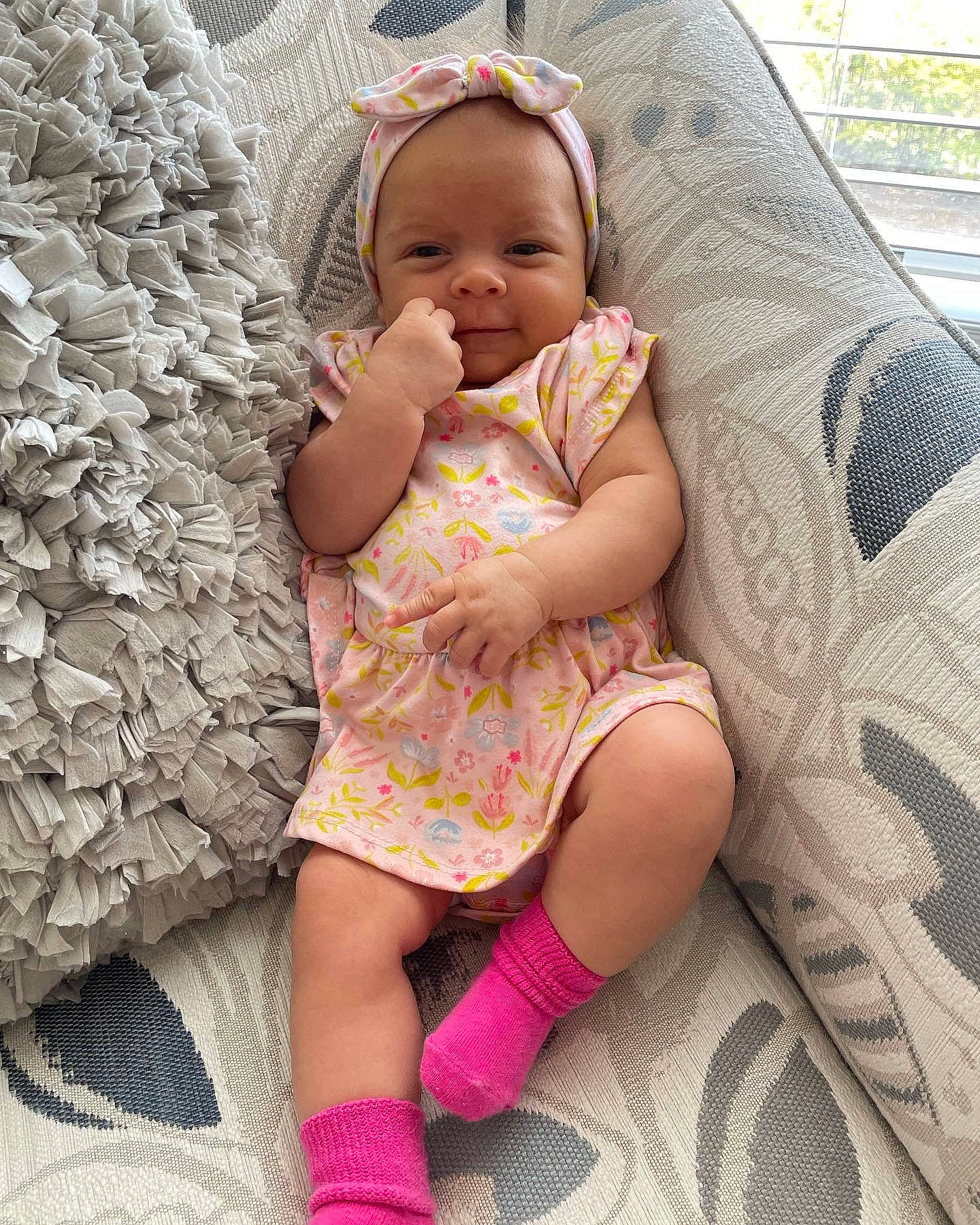 Brielle is registered to the contest to win money with this photo: arm, baby, baby_toddler_clothing, facial_expression, finger, grass, hairstyle, hand, happy, human_body, lip, neck, organ, person, pink, product, skin, sleeve, textile, thigh