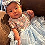 Armani joined the competition — help win amazing prizes! baby, child, dress, headband, blue, floral, cute, couch, indoor, portrait, infant, person, clothing, fabric, soft, seated, young, smiling, happy, adorable