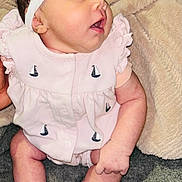Armani joined the competition — help win amazing prizes! baby, infant, headband, bow, pink_outfit, sailboat_pattern, sitting, blanket, cozy, curious, wide_eyes, open_mouth, cute, child, newborn, sock, indoor, soft_texture, young, person
