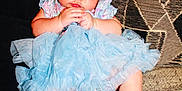 Armani joined the competition — help win amazing prizes! baby, child, girl, headband, flower, blue_dress, frills, socks, pink, couch, pillow, pattern, textile, indoor, infant, sitting, cute, soft, hands, focused