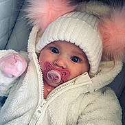 River joined the competition — help win amazing prizes! baby, child, pacifier, hat, pom_poms, white_jacket, knitted_hat, fluffy, cute, cold_weather, closeup, portrait, infant, warm_clothing, pink, blue_eyes, cozy, zipped_jacket, indoor, soft_texture