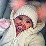 baby, child, pacifier, hat, pom_poms, white_jacket, knitted_hat, fluffy, cute, cold_weather, closeup, portrait, infant, warm_clothing, pink, blue_eyes, cozy, zipped_jacket, indoor, soft_texture