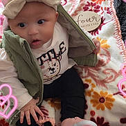 Na Veyah is registered to the contest to win money with this photo: adorable, baby, black_pants, bow_headband, carpet, child, clothing, cute, floral_blanket, four_months_tag, green_vest, heart_overlay, indoor, infant, pink_shoes, playful, portrait, sitting, white_shirt, young_child