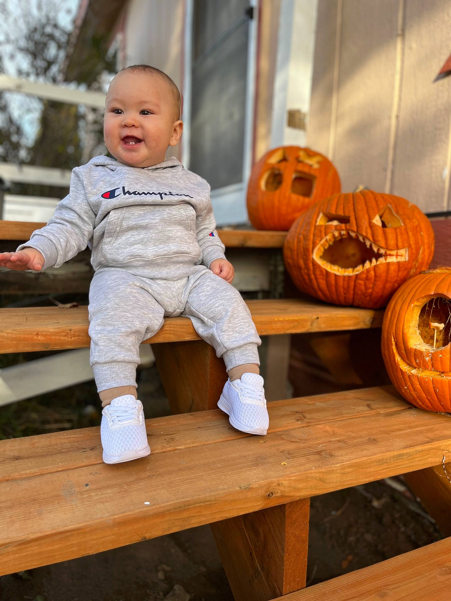 Raiden joined the competition — help win amazing prizes! baby, baby_toddler_clothing, calabaza, cucurbita, flooring, gourd, happy, jack_o_lantern, natural_foods, orange, person, produce, pumpkin, sitting, smile, squash, table, toddler, vegetable, winter_squash