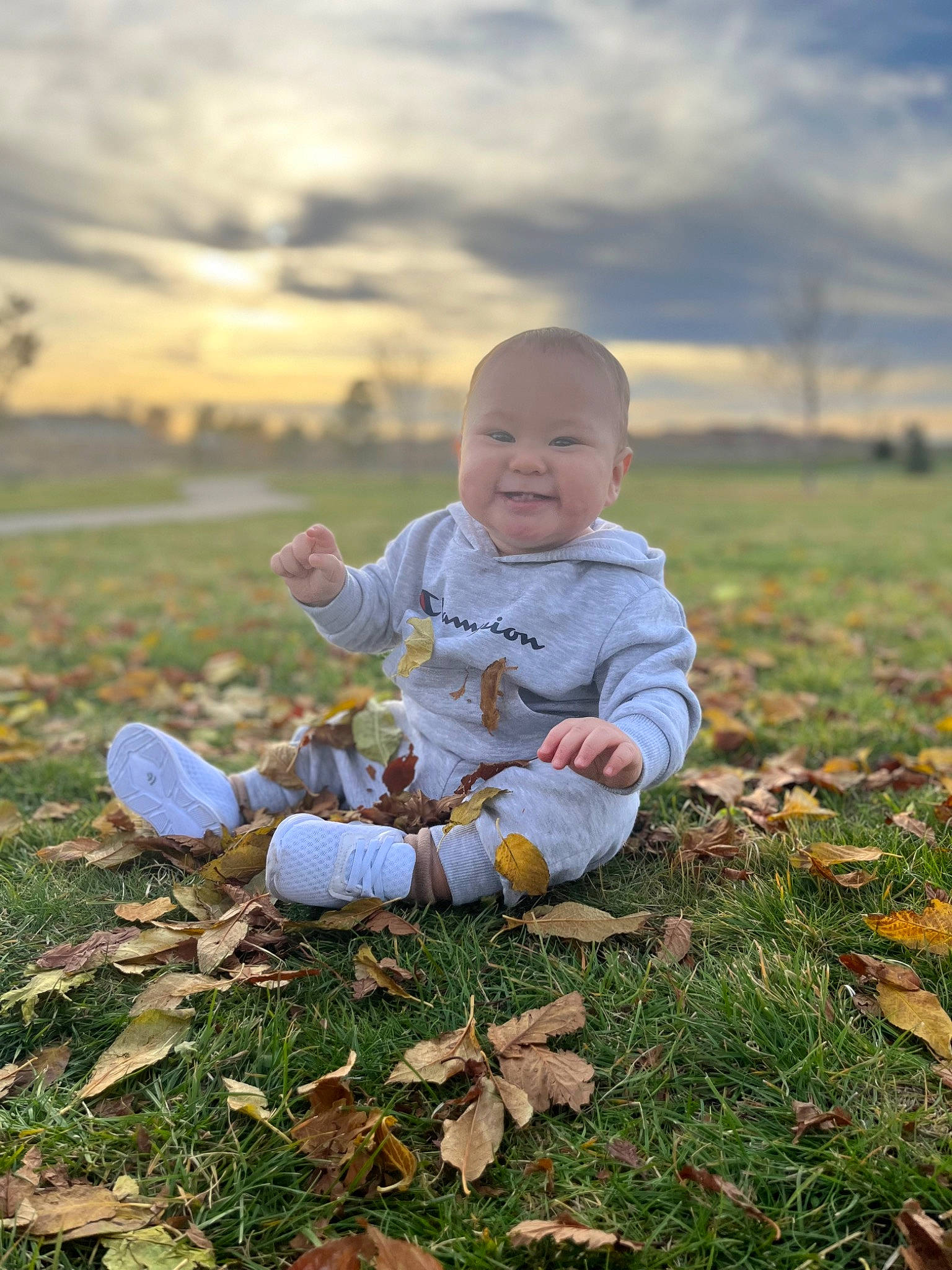 Raiden is registered to the contest to win money with this photo: baby, baby_toddler_clothing, cloud, face, flash_photography, grass, hand, happy, joy, landscape, leg, natural_environment, people_in_nature, person, plant, sky, smile, standing, sunlight, toddler
