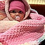 baby, blanket, bundle, child, closeup, cozy, cute, eyes, face, hat, hood, indoor, infant, knit, pacifier, pink, portrait, soft, warm, wrapped
