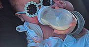 Brynlee is registered to the contest to win money with this photo: baby, bottle, milk, sunglasses, flower_shaped, onesie, infant, hand, person, cute, feeding, child, clothing, face, comfort, relaxation, indoor, portrait, holding, young