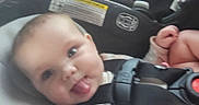 Brynlee is registered to the contest to win money with this photo: baby, car_seat, child, clothing, cute, expression, face, hands, head, indoors, infant, person, playful, safety_harness, seat, skin, smile, straps, tongue_out, young_child