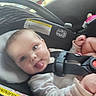 Brynlee is registered to the contest to win money with this photo: baby, car_seat, child, infant, tongue_out, safety_harness, cute, playful, indoors, person, seat, straps, young_child, face, head, clothing, skin, hands, expression, smile