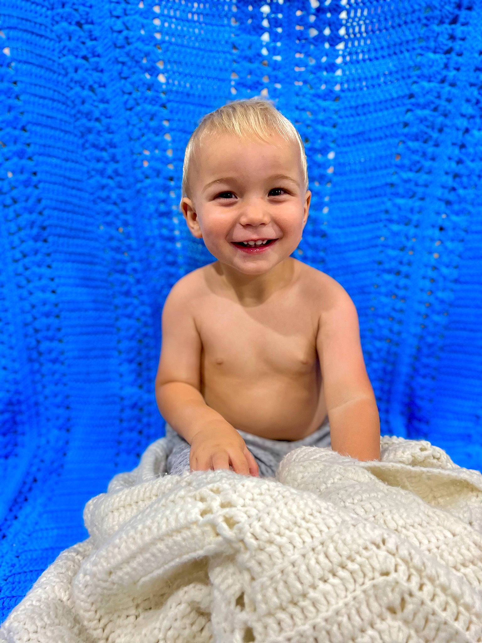 Dante is registered to the contest to win money with this photo: azure, baby, baby_toddler_clothing, barechested, blue, chest, child, chin, electric_blue, face, fun, happy, joy, leisure, linens, pattern, person, sitting, smile, toddler