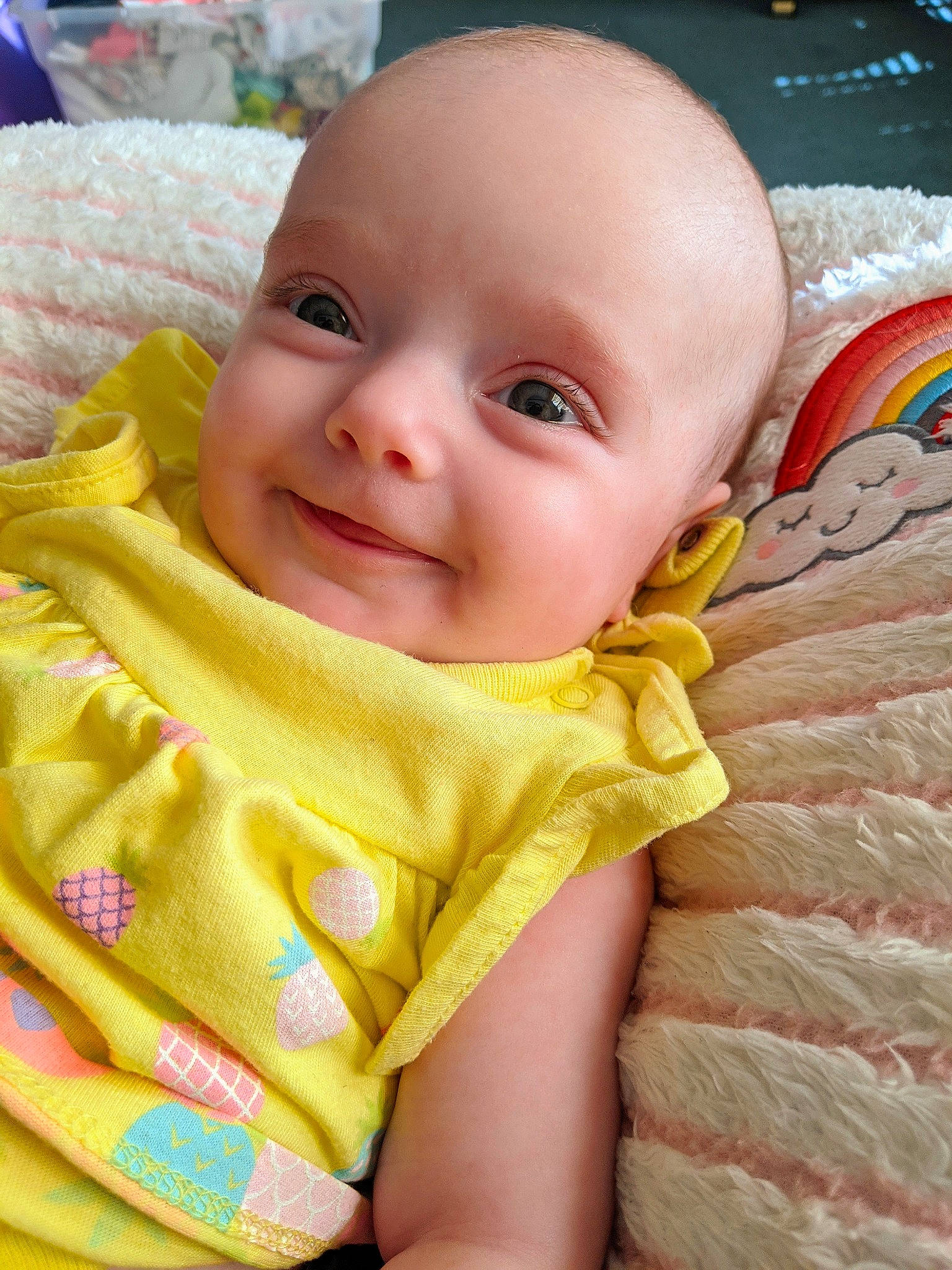 Calliope is registered to the contest to win money with this photo: baby, beauty, cheek, child, close_up, ear, eye, face, head, iris, joy, lip, mouth, nose, person, skin, smile, textile, toddler, yellow