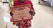 Winter joined the competition — help win amazing prizes! child, girl, certificate, preschool, classroom, smile, happy, dress, sandals, chairs, floor, education, celebration, achievement, indoor, people, hair, holding, person, background