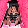 Luna is registered to the contest to win money with this photo: baby, infant, car_seat, pink, blanket, socks, clothing, seatbelt, child, person, newborn, portrait, indoors, cute, cozy, fabric, safety_harness, head, skin, small