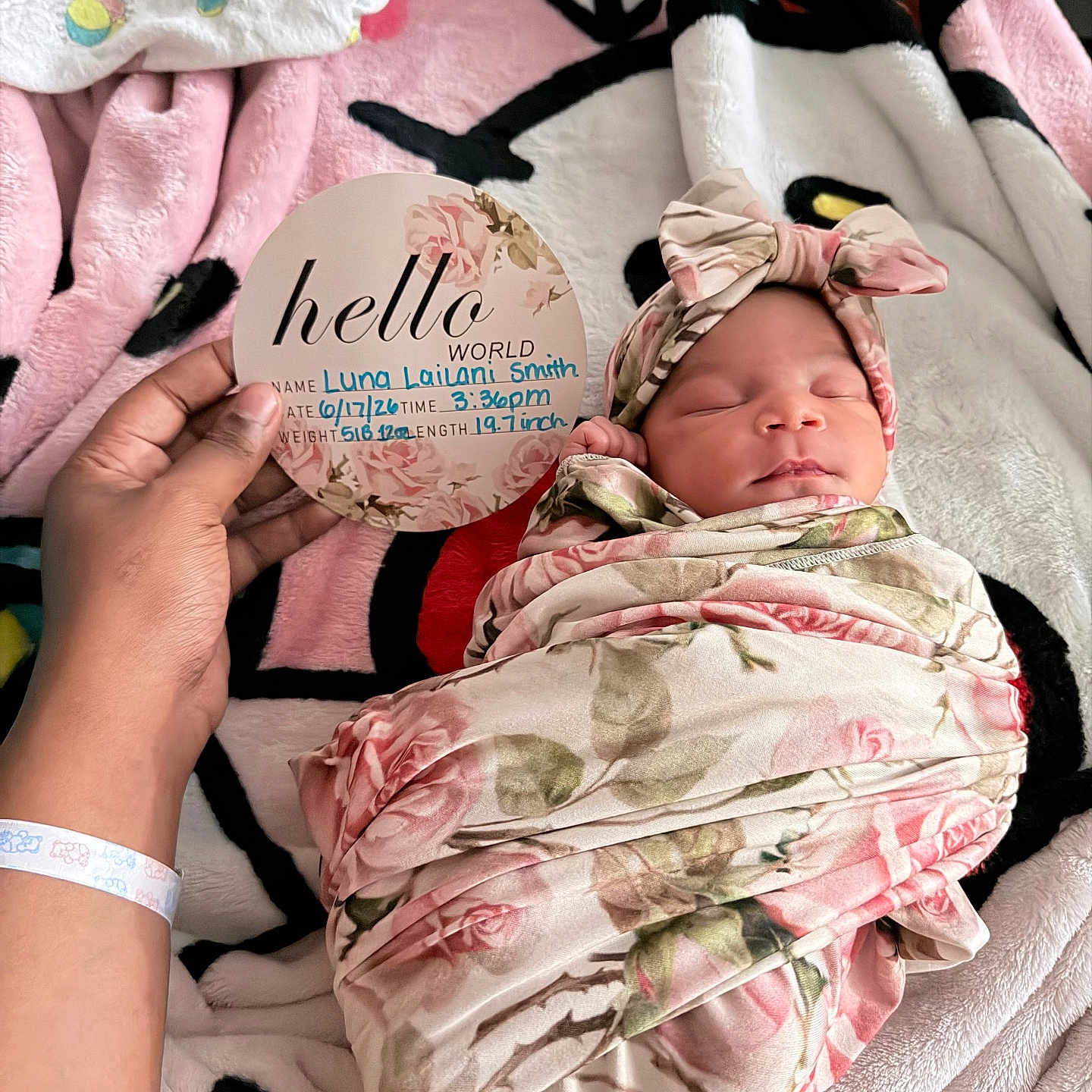 Luna joined the competition — help win amazing prizes! newborn, baby, swaddle, headband, sleeping, hand, card, blanket, floral_pattern, pink, white, black, red, person, infant, resting, soft_texture, portrait, indoors, cute