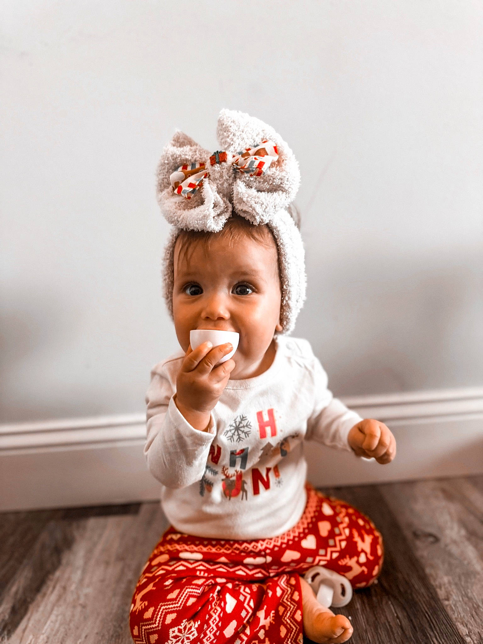 Indie joined the competition — help win amazing prizes! baby, baby_toddler_clothing, cap, child, clothing, costume_hat, fashion_accessory, happy, hardwood, hat, head, headband, headpiece, pattern, peach, person, pink, sitting, sleeve, toddler