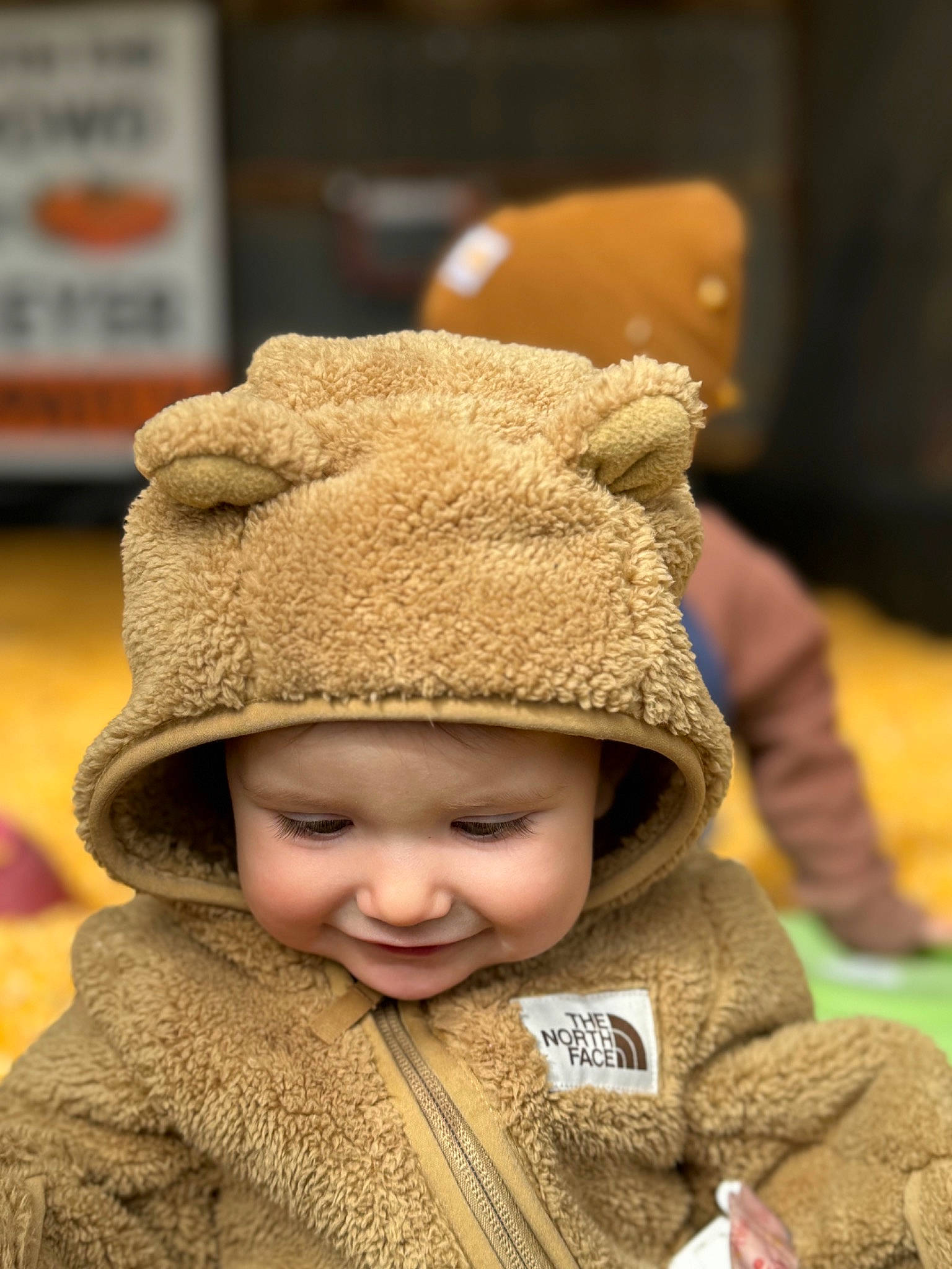 Indie is registered to the contest to win money with this photo: baby, beanie, cap, child, eye, fashion_accessory, fun, fur, happy, hat, headgear, headwear, jacket, knit_cap, person, sitting, skin, smile, toddler, winter