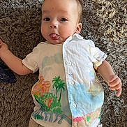 Roman joined the competition — help win amazing prizes! baby, infant, child, tongue_out, shirt, shorts, carpet, floor, lying_down, cute, playful, tropical_print, clothing, person, indoors, skin, face, arm, hand, expression