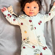 Echo is registered to the contest to win money with this photo: baby, infant, child, onesie, cute, smiling, face, hair, cushion, teddy_bear, soft, lying_down, indoors, happy, portrait, baby_clothes, small_feet, cozy, sleepwear, resting